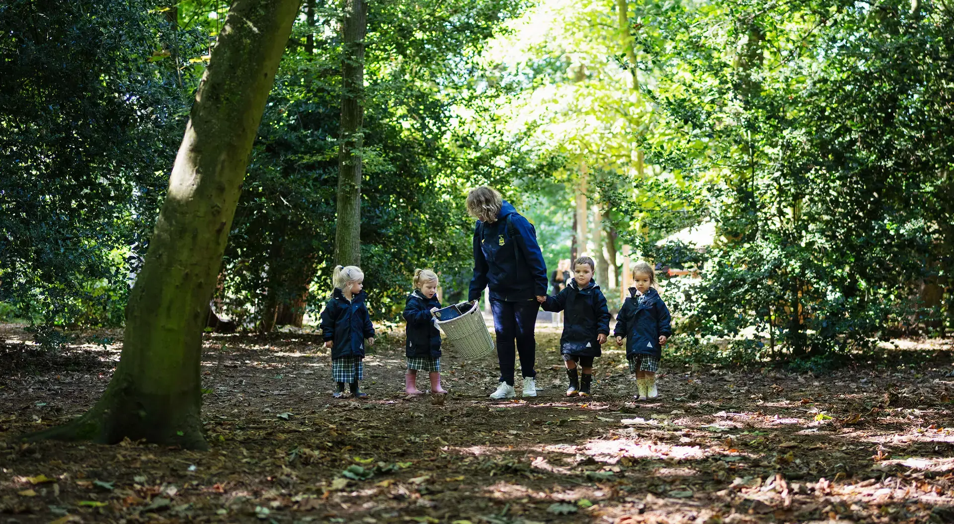 Pupils with teacher in the school grounds at Repton Prep